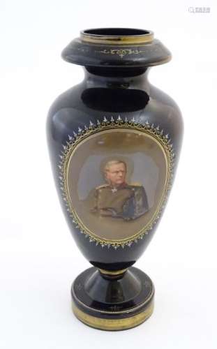 A black memorial glass vase decorated with a portrait