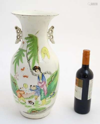 A 20thC Chinese twin handled baluster vase, decorated