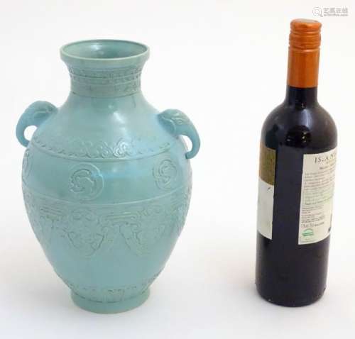 A Chinese celadon baluster vase with twin handles