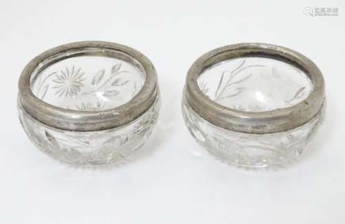 A pair of cut glass salts with silver rims, hallmarked