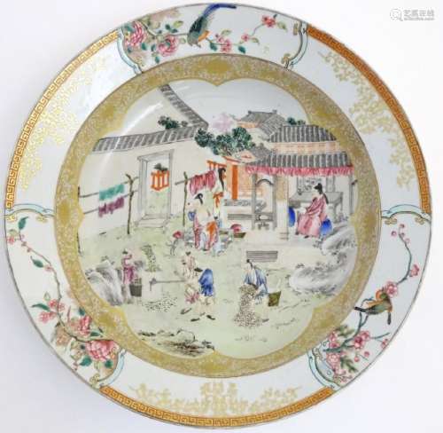 A large Chinese bowl with hand painted scenes of rural