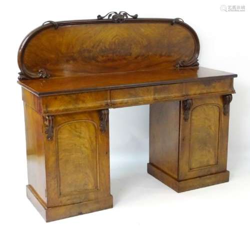 A Victorian mahogany sideboard with carved floral