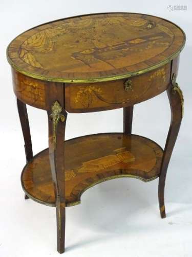 A 19thC French centre table with an oval top and brass