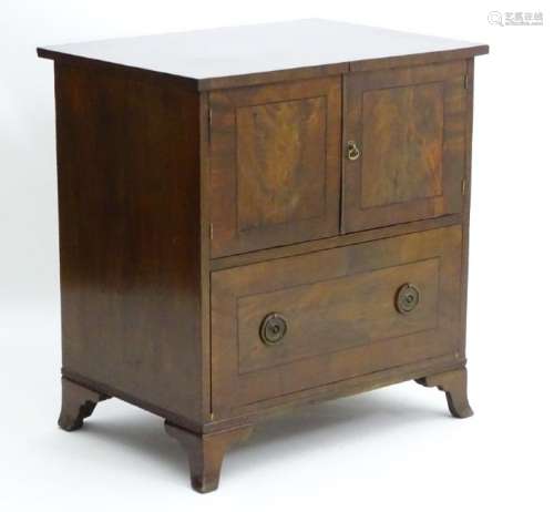 An early 19thC mahogany side cabinet with flame
