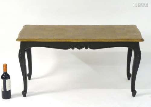 An early 20thC Louis XV style coffee table with an oak