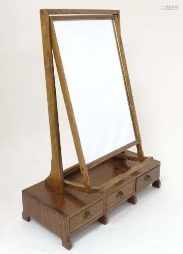 A mid 20thC Cotswold school toilet mirror, having an