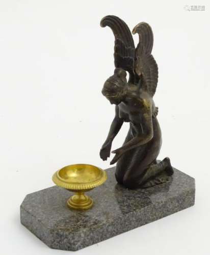 Regency patinated bronze  An angel kneeling before a