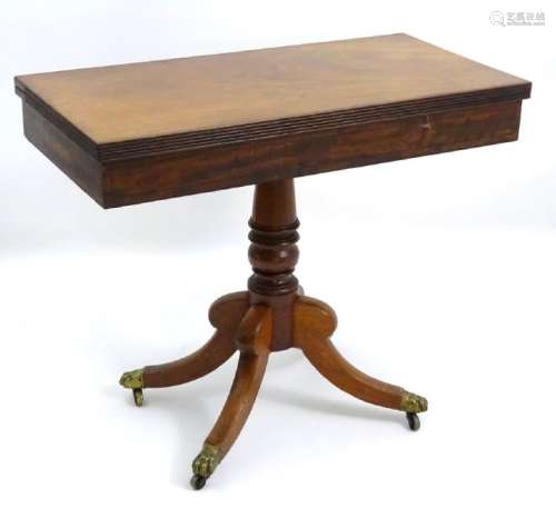 A mid 19thC mahogany tea table with a reeded
