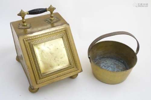 Circa 1900, a brass fireside coal scuttle with ebonised