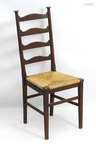 An Arts and Crafts ladder back chair with an envelope