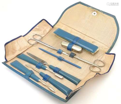 A 1950s manicure set in a folding silk lined turquoise