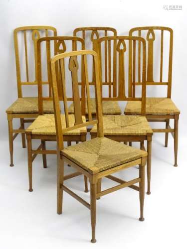 A set of six oak Arts and Crafts dining chairs with