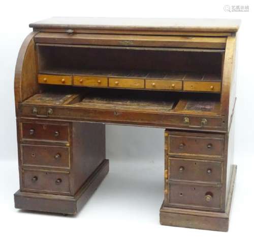 A mid / late 19thC mahogany roll top bureau with a