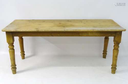 A late 19thC / early 20thC pine kitchen table standing