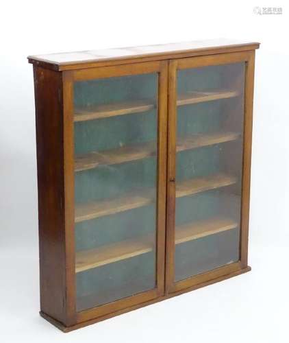 An early 20thC mahogany bookcase with a moulded top,