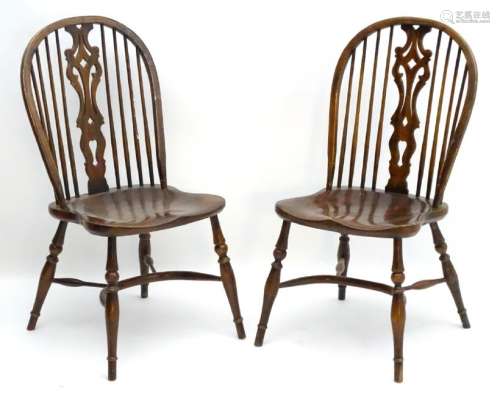A pair of early 20thC Windsor chairs with a wheelback
