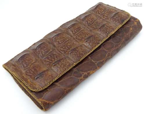 An early to mid 20thC crocodile clutch bag with