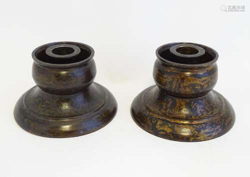 A pair of unusual Chinese cast bronze candlesticks with