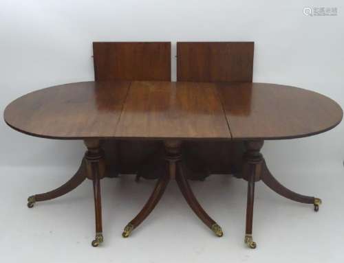 An early 20thC mahogany triple pedestal dining table,