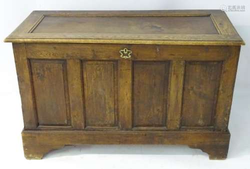 An 18thC oak coffer with panelled front and sides, lid