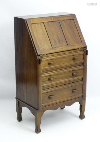 An early 20thC walnut bureau with a paneled fall