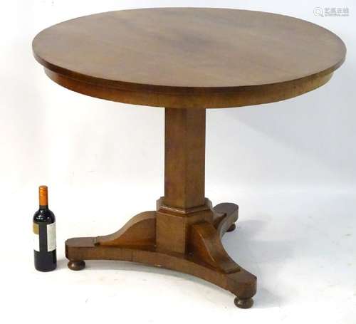 A mid / late 19thC mahogany tilt top table with a