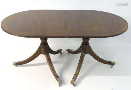 An early 20thC mahogany Regency style dining table,