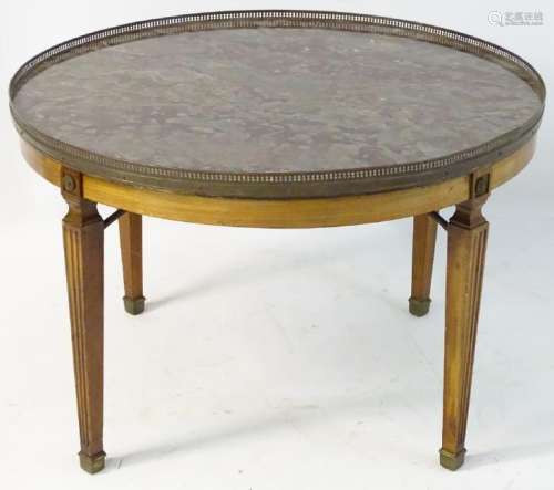 A mid 19thC mahogany table with marble top and brass