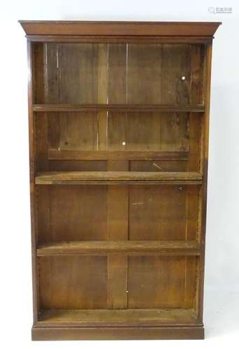 An early 20thC bookcase with adjustable shelving above