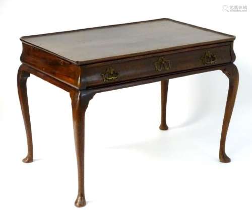 A 19thC mahogany silver table with a raised outer edge,