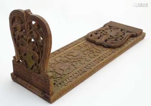 A large South Asian carved wooden extending book slide