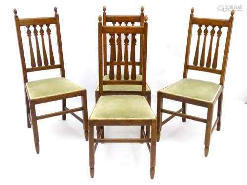 A set of four oak Arts and Crafts dining chairs with