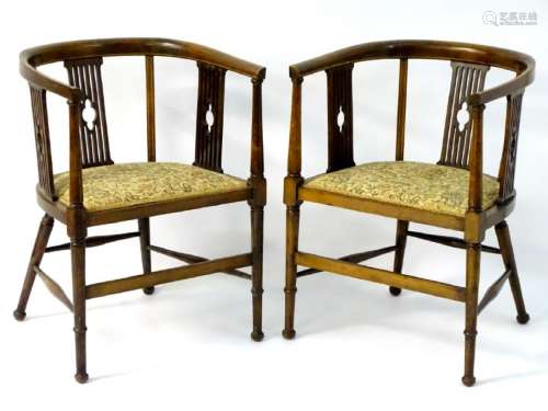 A pair of Edwardian mahogany tub chairs with slatted