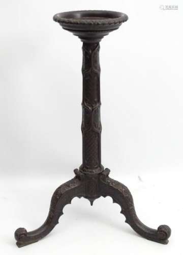 An early 20thC mahogany jardiniere stand with carved