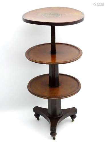 A William IV mahogany three tier dumb waiter, having a