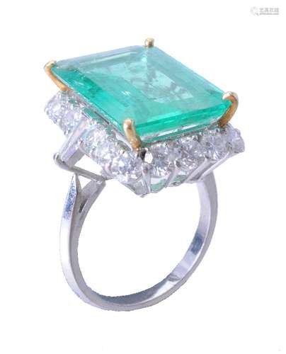 An emerald and diamond cluster ring