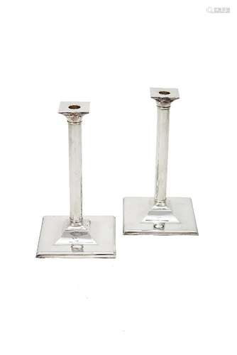 A pair of plain silver candlesticks by Theo Fennell