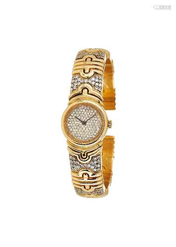 A gold coloured and diamond sprung bangle watch