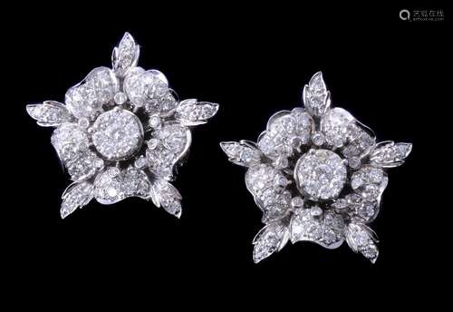 A pair of diamond flower head earrings