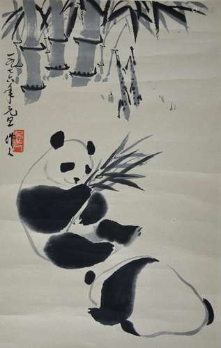 A Chinese printed scroll picture of two pandas amongst bamboo; with calligraphy and red seal mark,