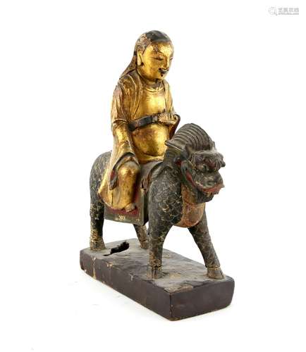 A Chinese gilded wood figure of a Deity or Scholar, seated on the back of a Kylin, possibly intended