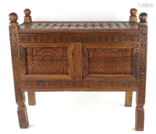 A small Indian hardwood Dowry Chest on shaped supports, carved with rows of stylised botanical or