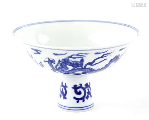 A Chinese blue and white stem cup, decorated with a dragon and a phoenix, 15.5cm diameter, six-