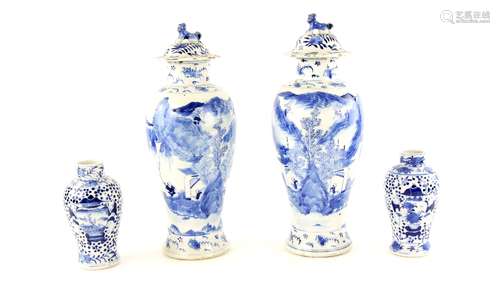 Two pairs of Chinese blue and white vases: the larger pair with domed covers and Buddhistic Lion