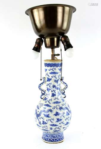 A Chinese blue and white vase, decorated with confronting dragons beside a flaming pearl; the base