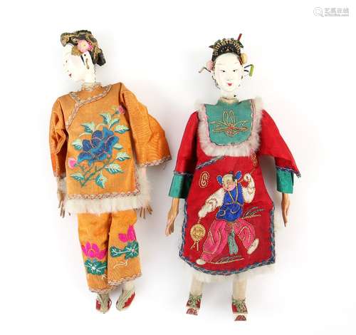 Two Chinese Dolls: one wearing a fur-fringed tunic with green sleeves; the other wearing an orange