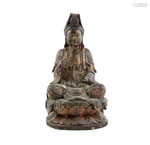 A carved wood figure of The Bodhisattva of Mercy, Guanyin; seated on a lotus base and wearing