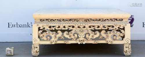 A Chinese white lacquered [or other process imitating ivory] low table decorated with archaistic,