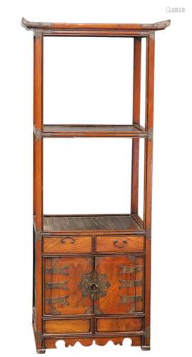 A Korean wood stand, designed with an arrangement of three shelves above a pair of hinged doors