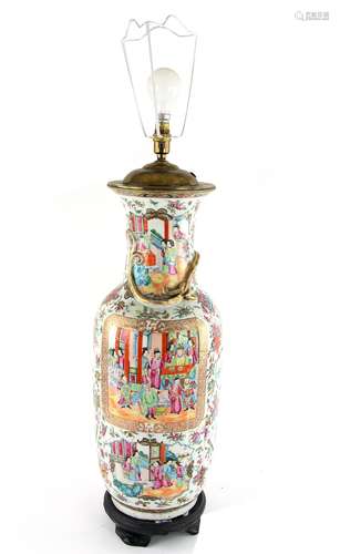 A Canton famille rose vase, decorated with floral designs and sacred objects amongst panels